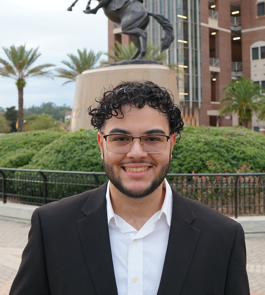 Image of Dominick Diaz, founder of High Tide, in front of FSU in a suit
