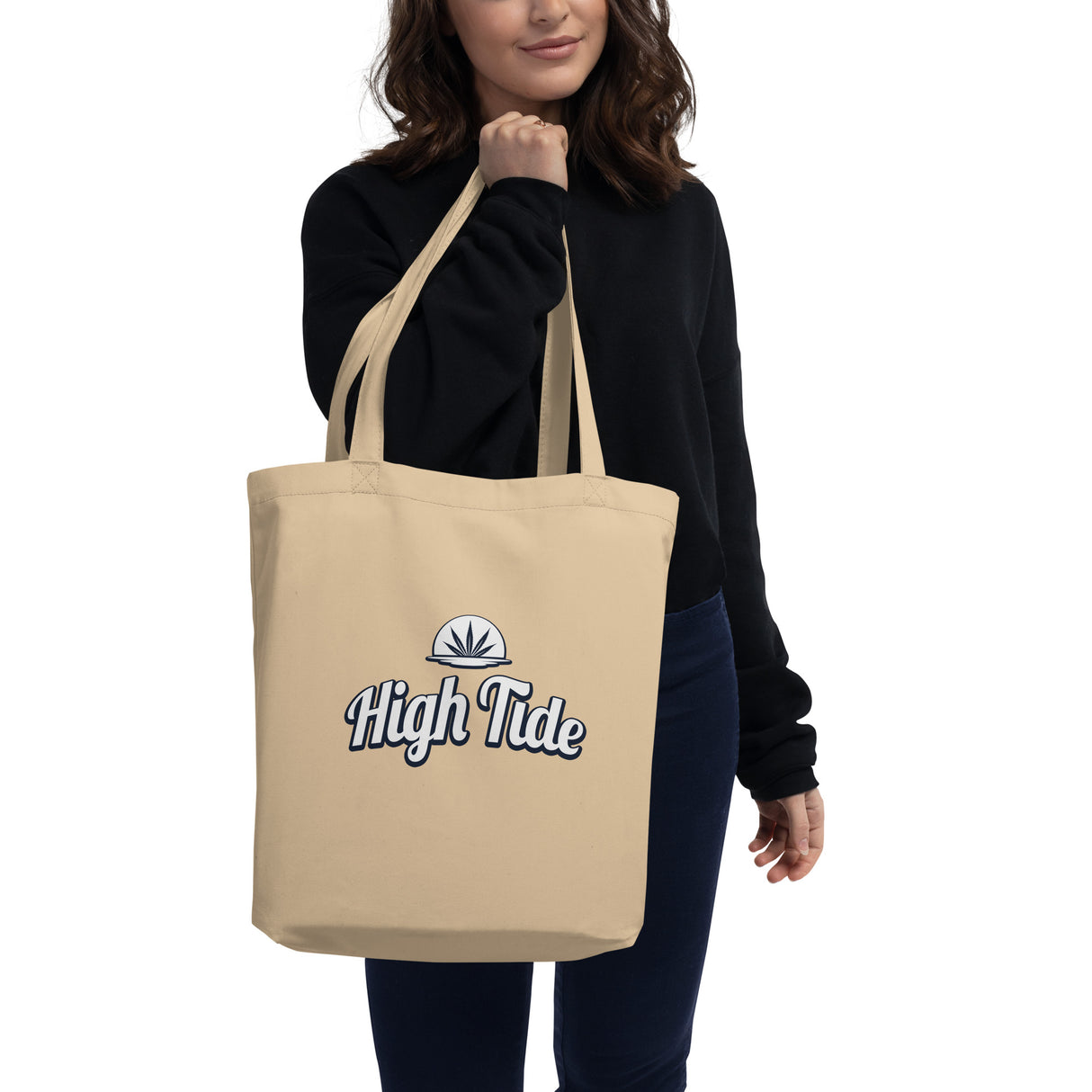 Model wearing High Tide Eco Tote Bag with High Tide Papers logo showing