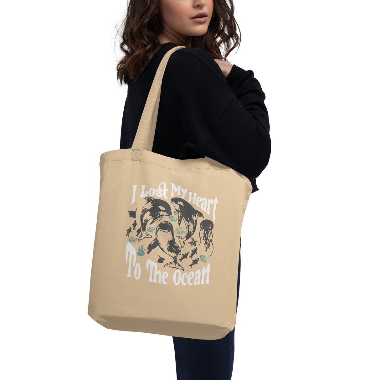 Model wearing High Tide Eco Tote Bag with graphic that says I Lost my Heart to the Ocean