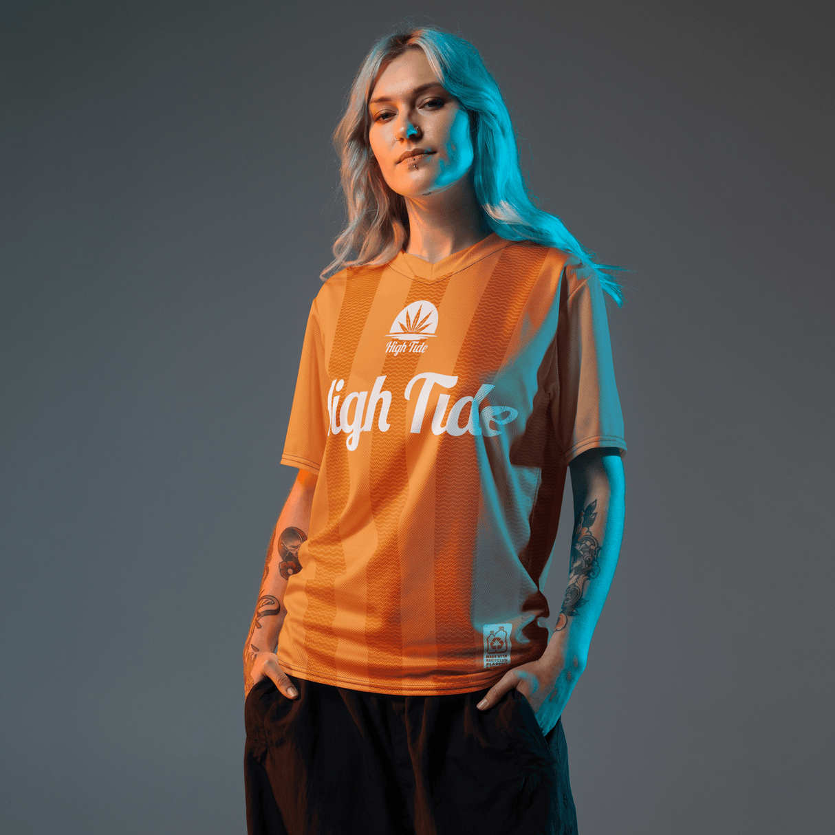 Woman model wearing High Tide Soccer Jersey (2024) with grey backdrop.