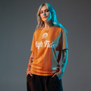 Woman model wearing High Tide Soccer Jersey (2024) with grey backdrop.